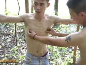 Cute asian boy bound in the wood